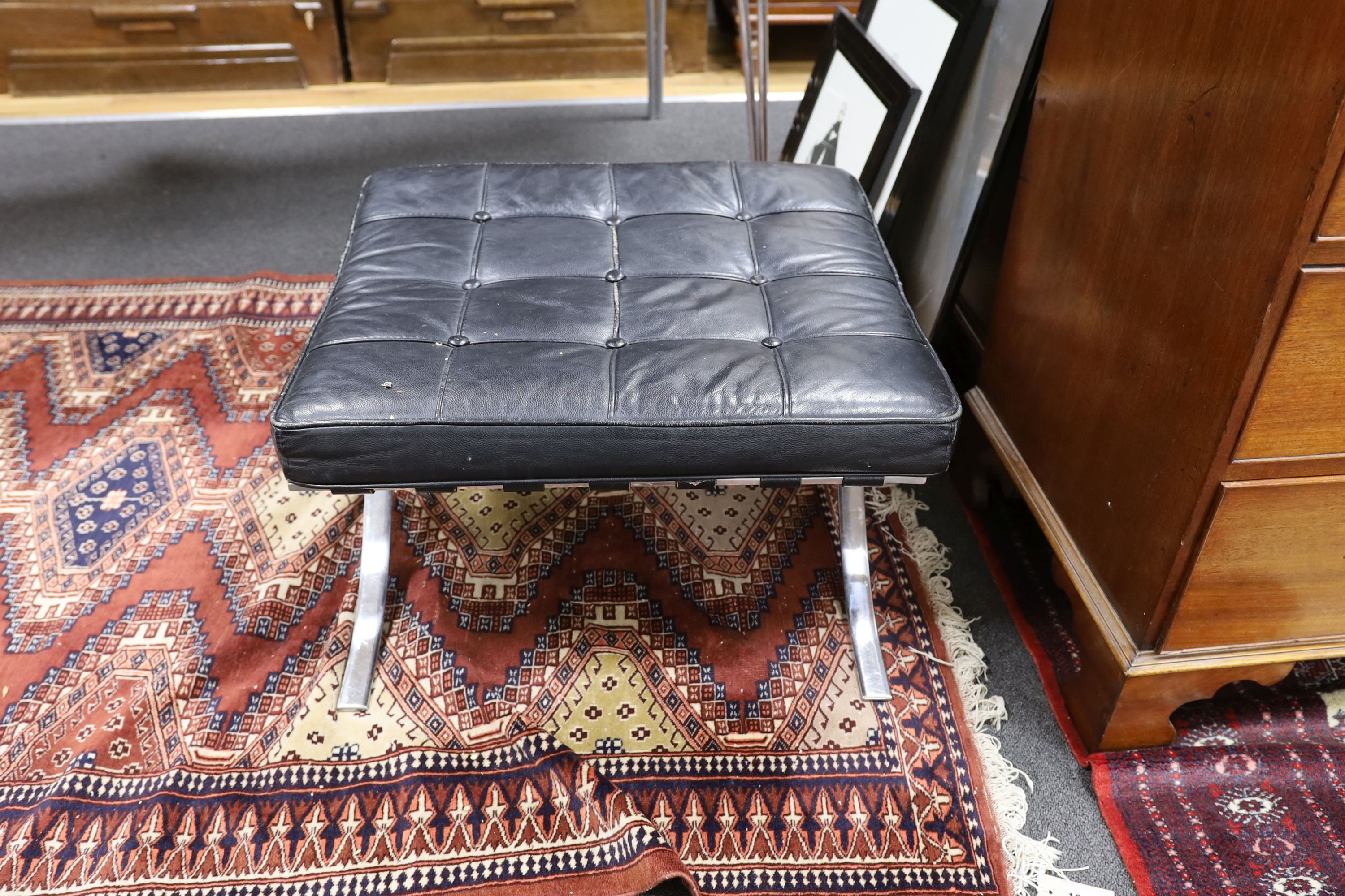 A Barcelona style black leather and chrome footstool, length 64cm, depth 57cm, height 37cm